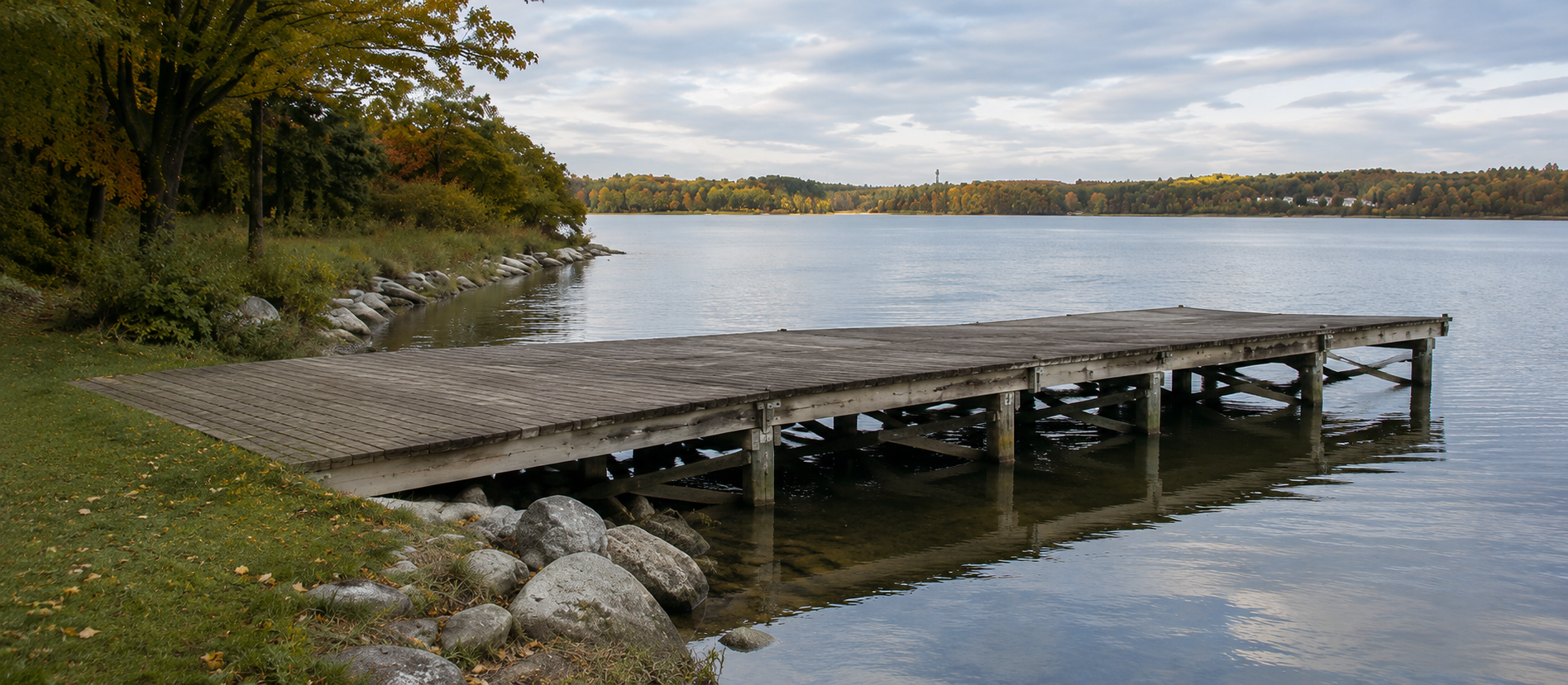 A long wooden dock over calm water, representing the path from income sources to timing decisions.